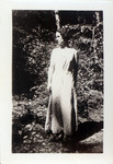 Woman posing in front of a small tree thumbnail