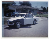 Michele Serros standing next to a car thumbnail
