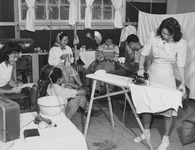 [Teenage incarcerees spending Sunday afternoon in various activities such as ironing, playing cards, etc. at Granada incarceration camp] thumbnail