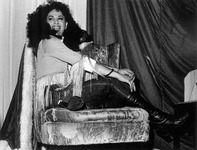 Female impersonator wearing jeans and boots. thumbnail