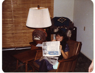 Michele Serros with a newspaper thumbnail