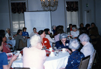 Women at dining tables listening to a speaker thumbnail