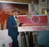 Alfredo de Batuc with Paintings in Artist's Studio thumbnail