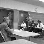 President Robert Clark meets with students in a classroom. thumbnail