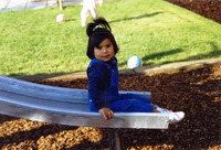 Girl sitting at the bottom of a slide thumbnail