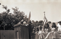 [President Robert E. Kennedy displays a photo on stage in front of Poly Princess candidates?] thumbnail