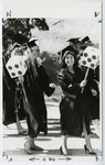 [Two women graduates holding die at commencement] thumbnail