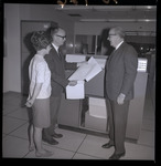 Group consults printouts from mainframe computers thumbnail