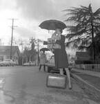Young woman with a suitcase on the street thumbnail