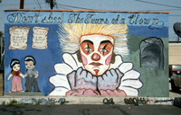 Dedication Mural Depicting a Sad Clown and Hispanic Couple thumbnail