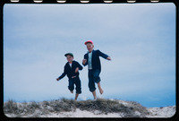 Boys fly over the dunes thumbnail